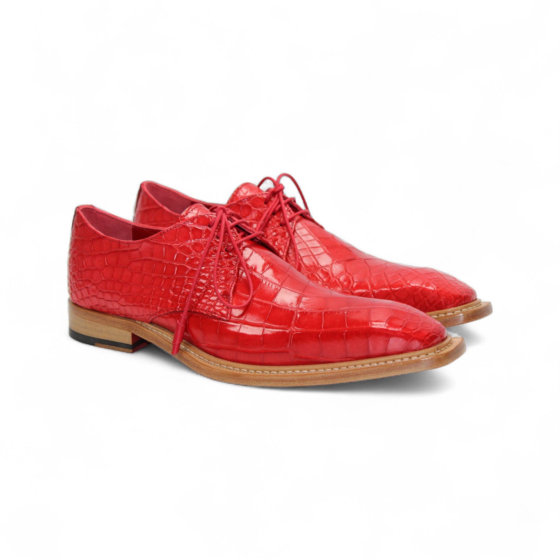 The Fennix Rowan Red by Fennix of Italy—a single red oxford crafted from genuine alligator leather with laces and a light brown wooden sole—is displayed in side profile against a white background, perfect for any luxury shoe collection.