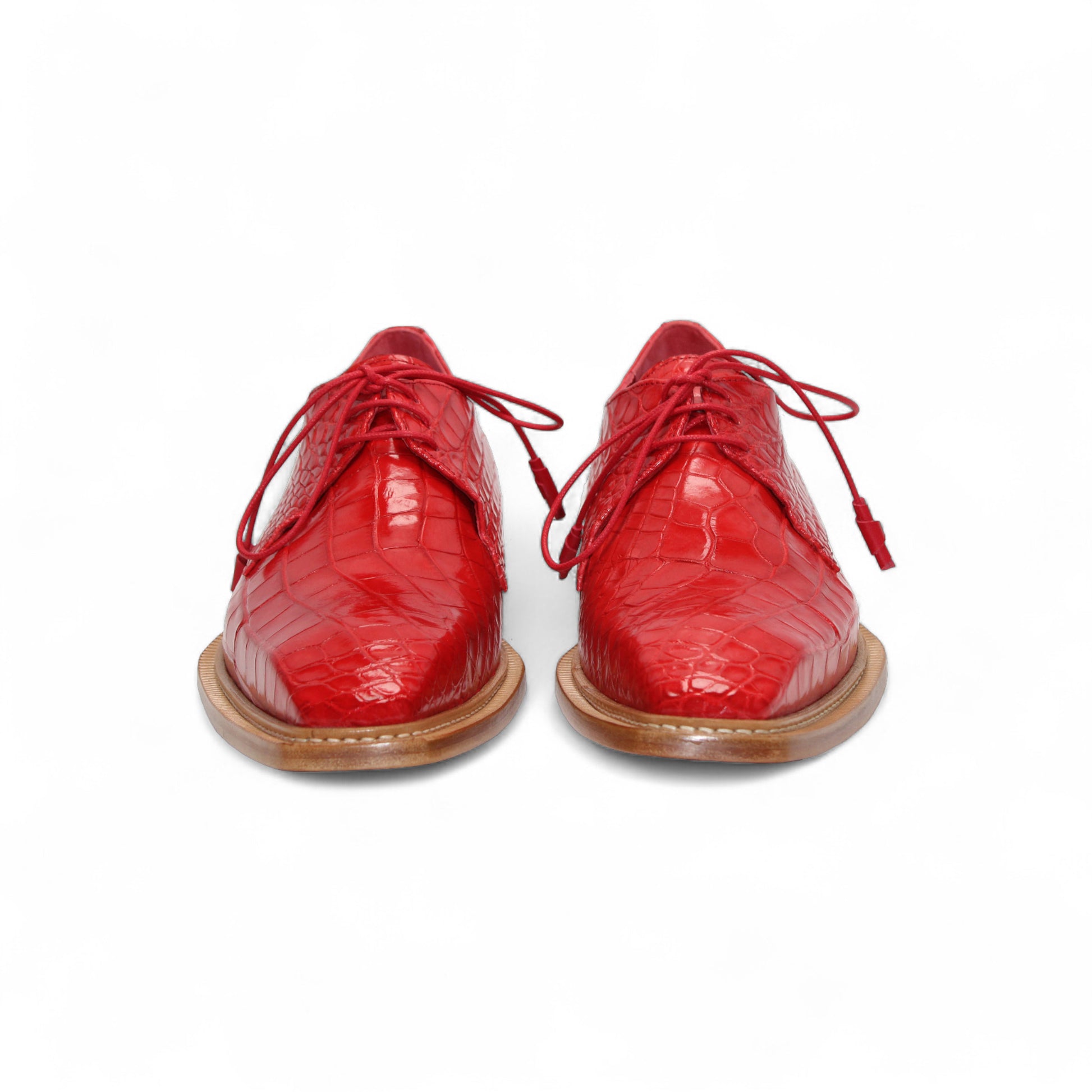 The Fennix Rowan Red by Fennix of Italy—a single red oxford crafted from genuine alligator leather with laces and a light brown wooden sole—is displayed in side profile against a white background, perfect for any luxury shoe collection.