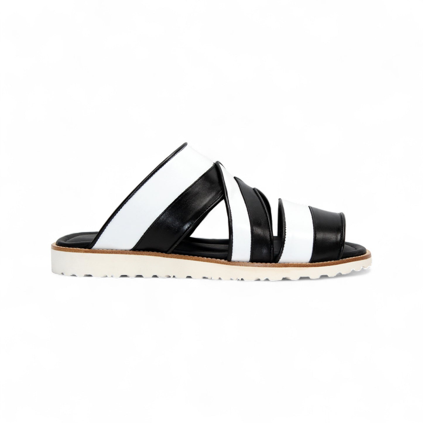 The Duca Di Matiste Duca SA118 Black/White slip-on sandal features crisscross straps and a flat, ridged sole, shown from the side on a white background—showcasing modern Italian-inspired shoe design.