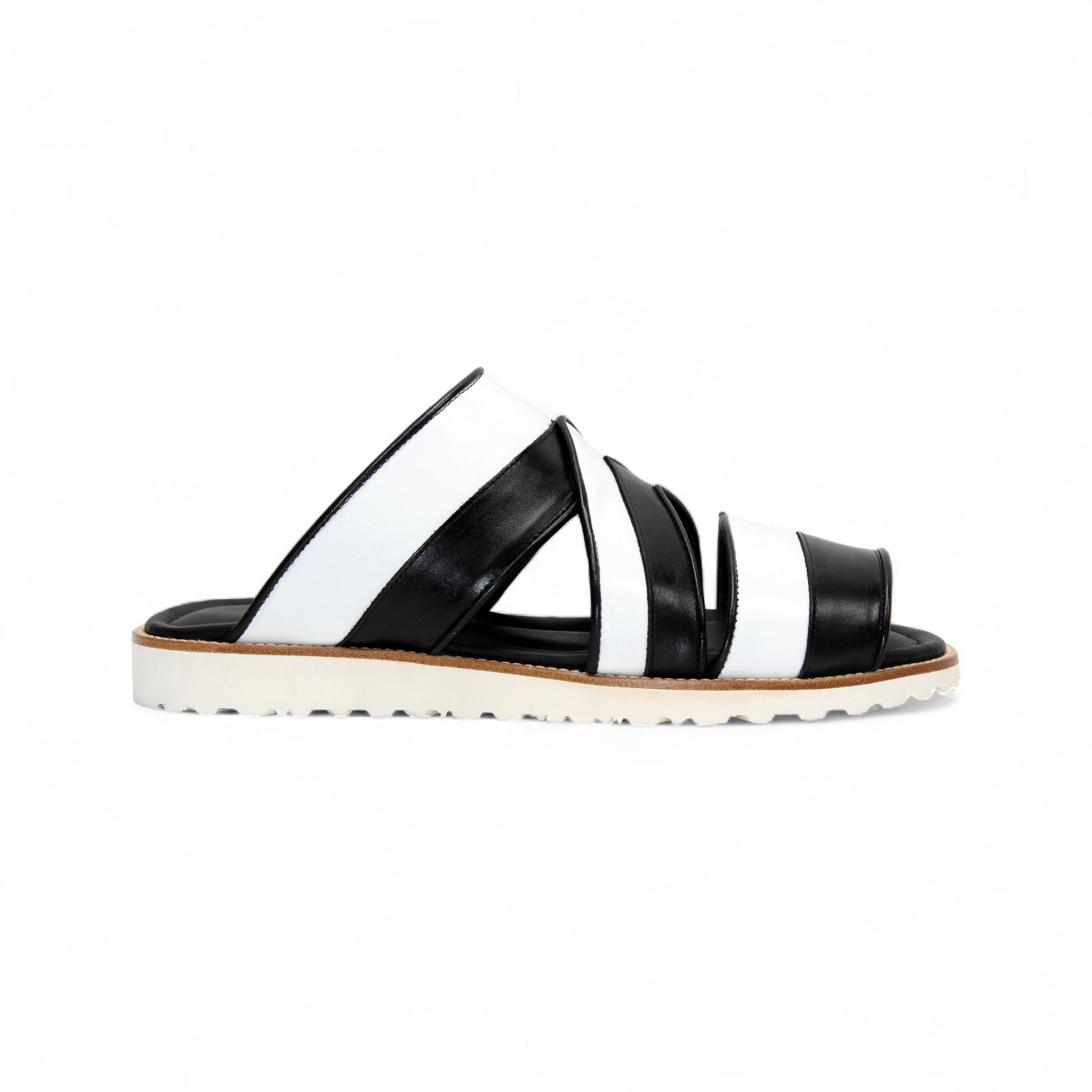 The Duca Di Matiste Duca SA118 Black/White slip-on sandal features crisscross straps and a flat, ridged sole, shown from the side on a white background—showcasing modern Italian-inspired shoe design.
