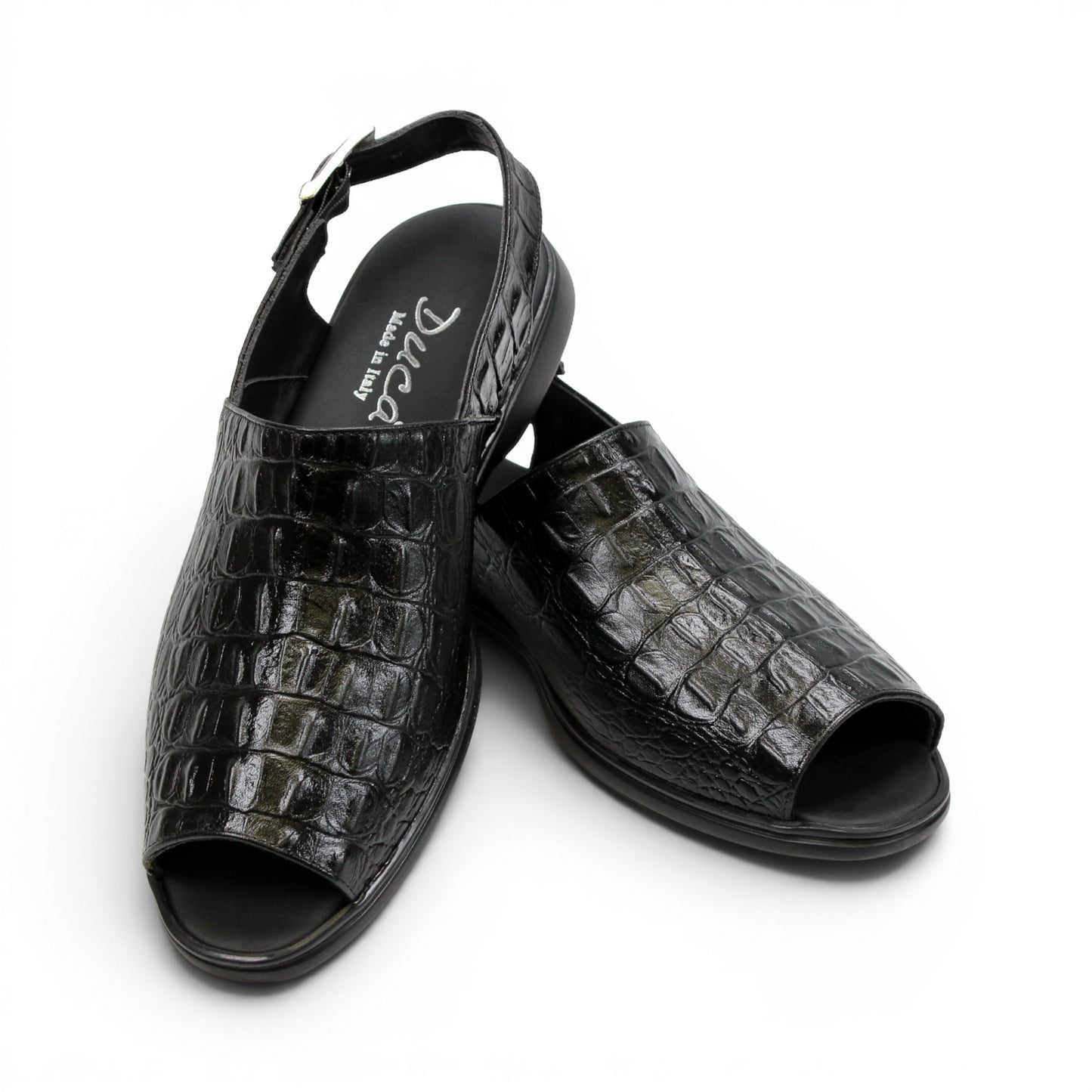 The Duca Di Matiste Duca SA136 Black sandal features faux-crocodile texture, open toe, closed back, adjustable buckle strap, and flat sole. Shown in side view on a white background.