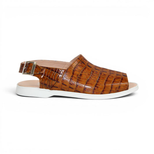 The Duca Di Matiste Duca SA136 Cognac sandal features brown crocodile-patterned calf leather, a closed toe, adjustable buckle strap, and white flat sole for modern comfort, shown on a white background.