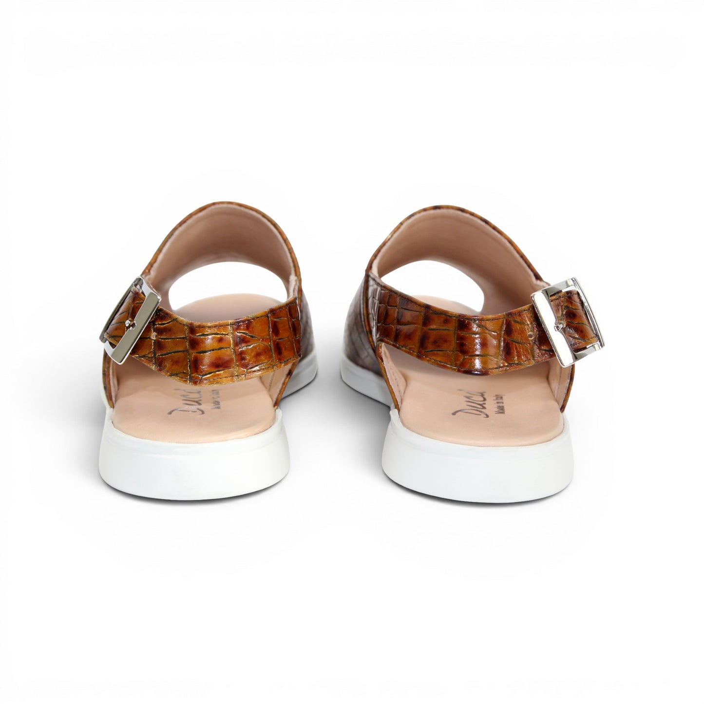 The Duca Di Matiste Duca SA136 Cognac sandal features brown crocodile-patterned calf leather, a closed toe, adjustable buckle strap, and white flat sole for modern comfort, shown on a white background.