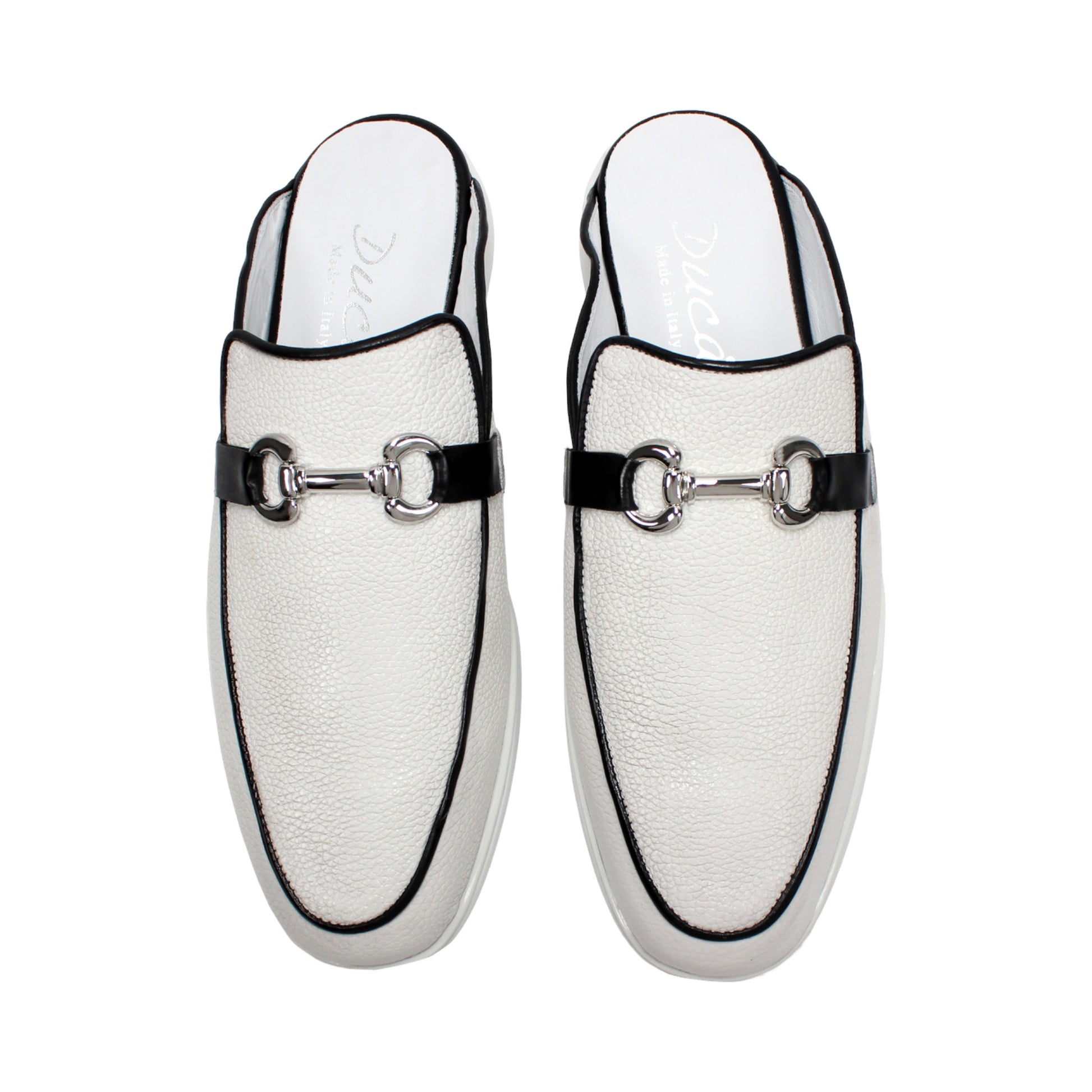 The Duca Di Matiste Duca SA493 White/Black is a white Italian leather slip-on mule with a black trim, low heel, metal buckle, and durable rubber sole, shown in profile against a plain white background.