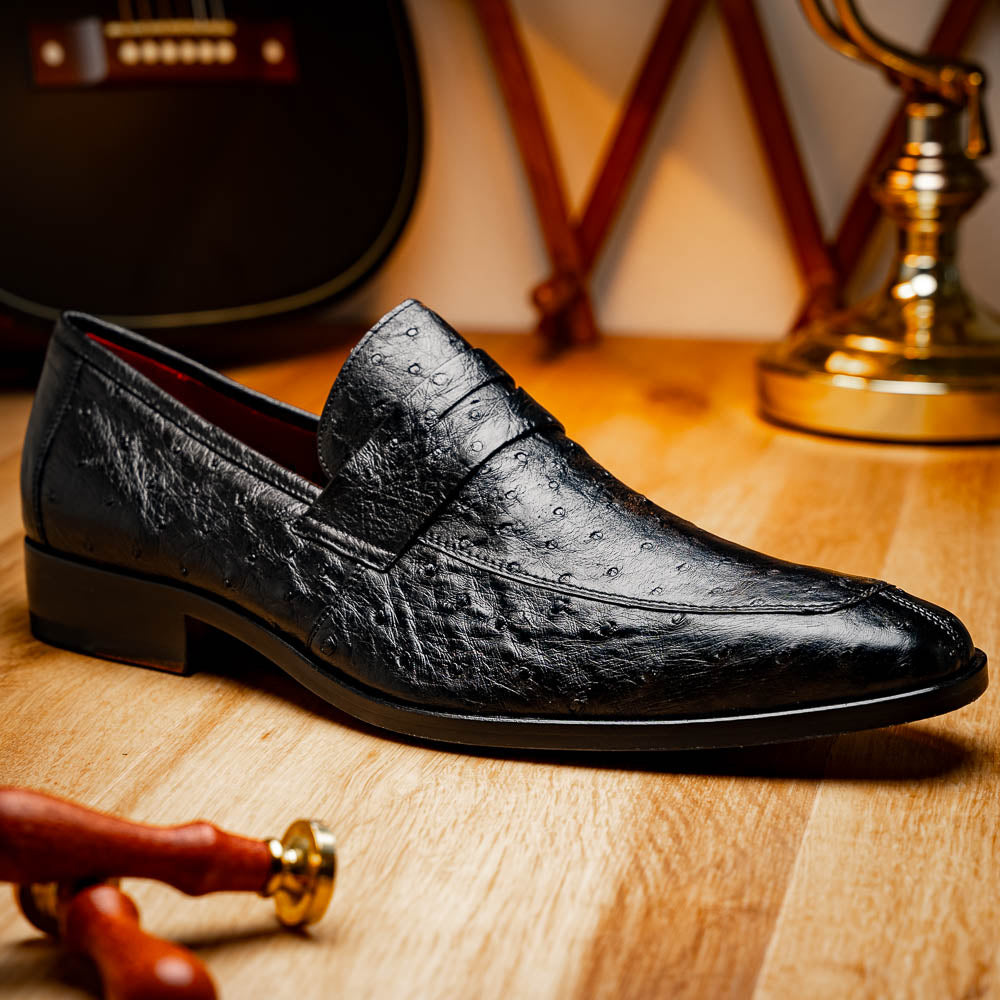 The Salvatore Black by Marco Di Milano is a pair of genuine ostrich leather loafers in black with a brown leather sole, detailed stitching, and an embossed brand logo on the outsole—ideal for luxury footwear enthusiasts.