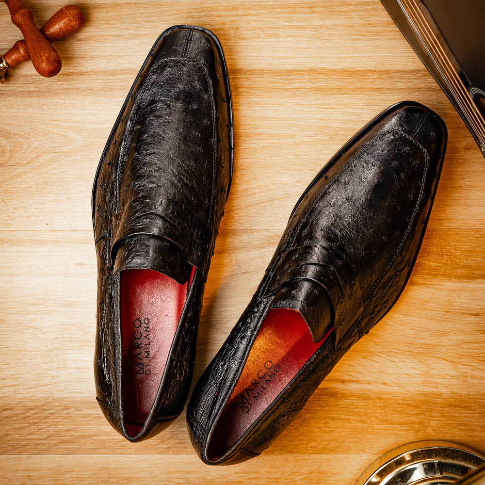 The Salvatore Black by Marco Di Milano is a pair of genuine ostrich leather loafers in black with a brown leather sole, detailed stitching, and an embossed brand logo on the outsole—ideal for luxury footwear enthusiasts.