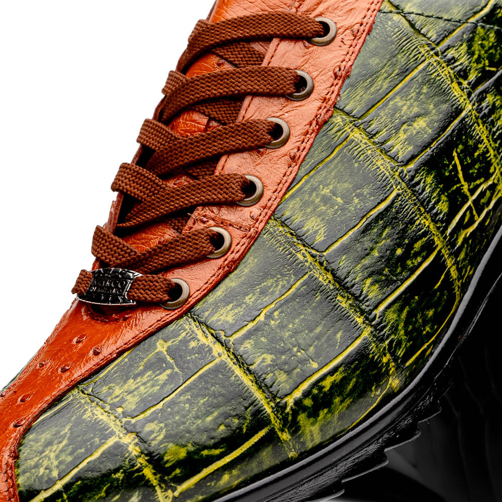 The Saulo Green / Cognac by Marco Di Milano is a luxury men's sneaker with an orange and green crocodile pattern, brown laces, black sole, and metallic tongue emblem—ideal for those wanting an authentic alligator look.