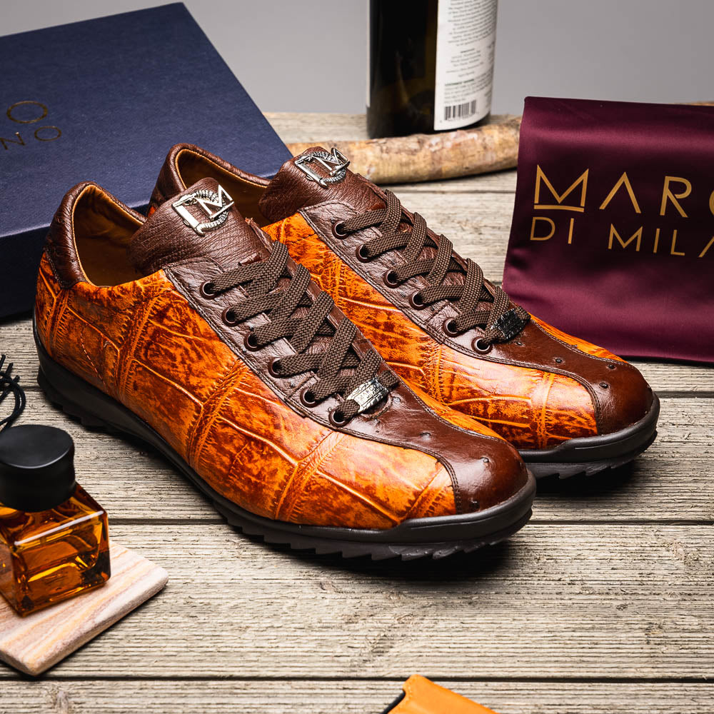 The Saulo Brandy / Brown sneakers by Marco Di Milano feature genuine brown alligator, black soles, dark brown laces, and metallic logo accents—luxury men's footwear displayed against a white background.
