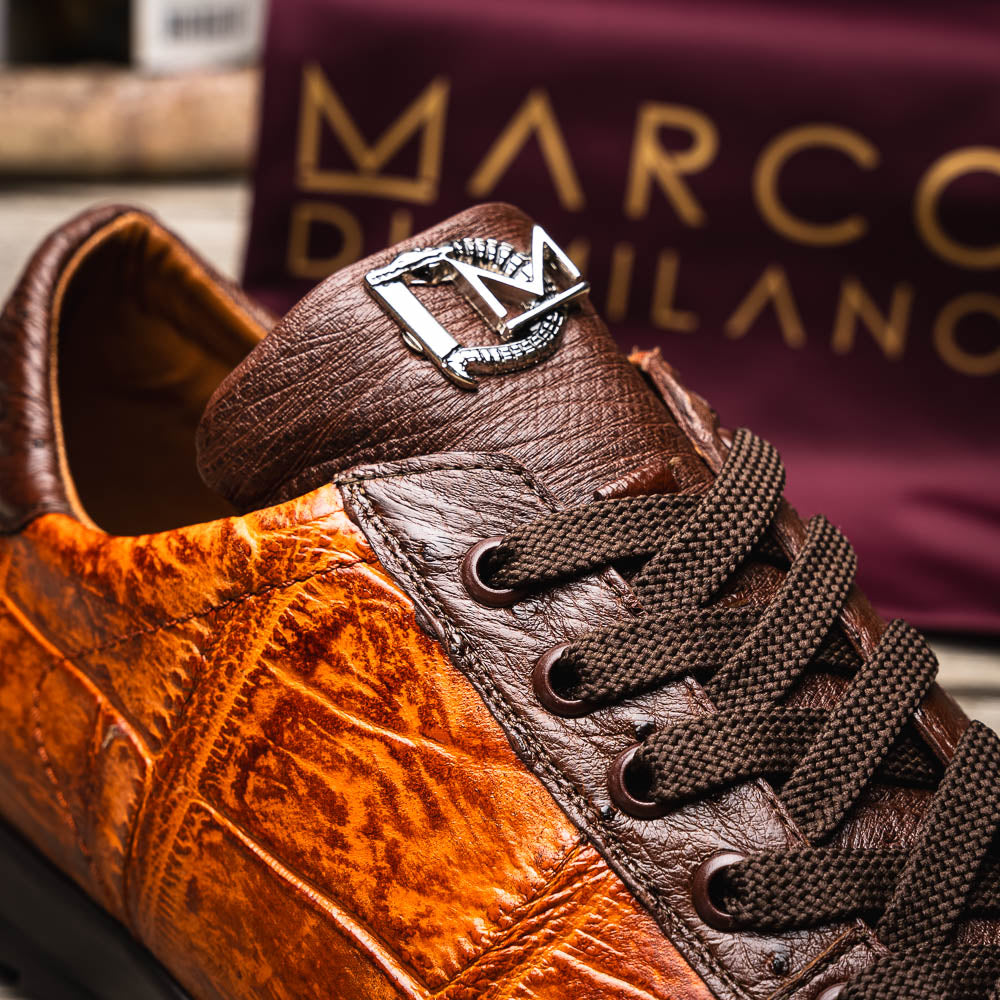 The Saulo Brandy / Brown sneakers by Marco Di Milano feature genuine brown alligator, black soles, dark brown laces, and metallic logo accents—luxury men's footwear displayed against a white background.