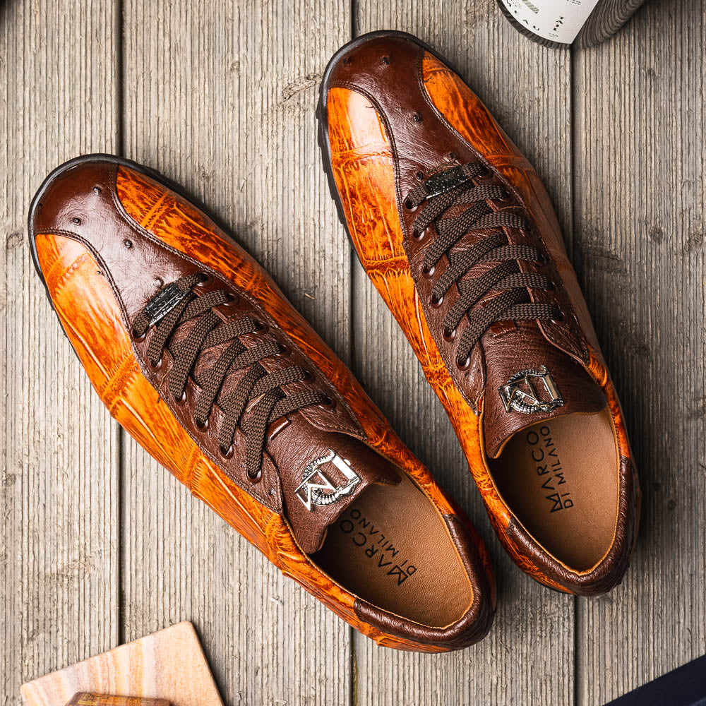 The Saulo Brandy / Brown sneakers by Marco Di Milano feature genuine brown alligator, black soles, dark brown laces, and metallic logo accents—luxury men's footwear displayed against a white background.