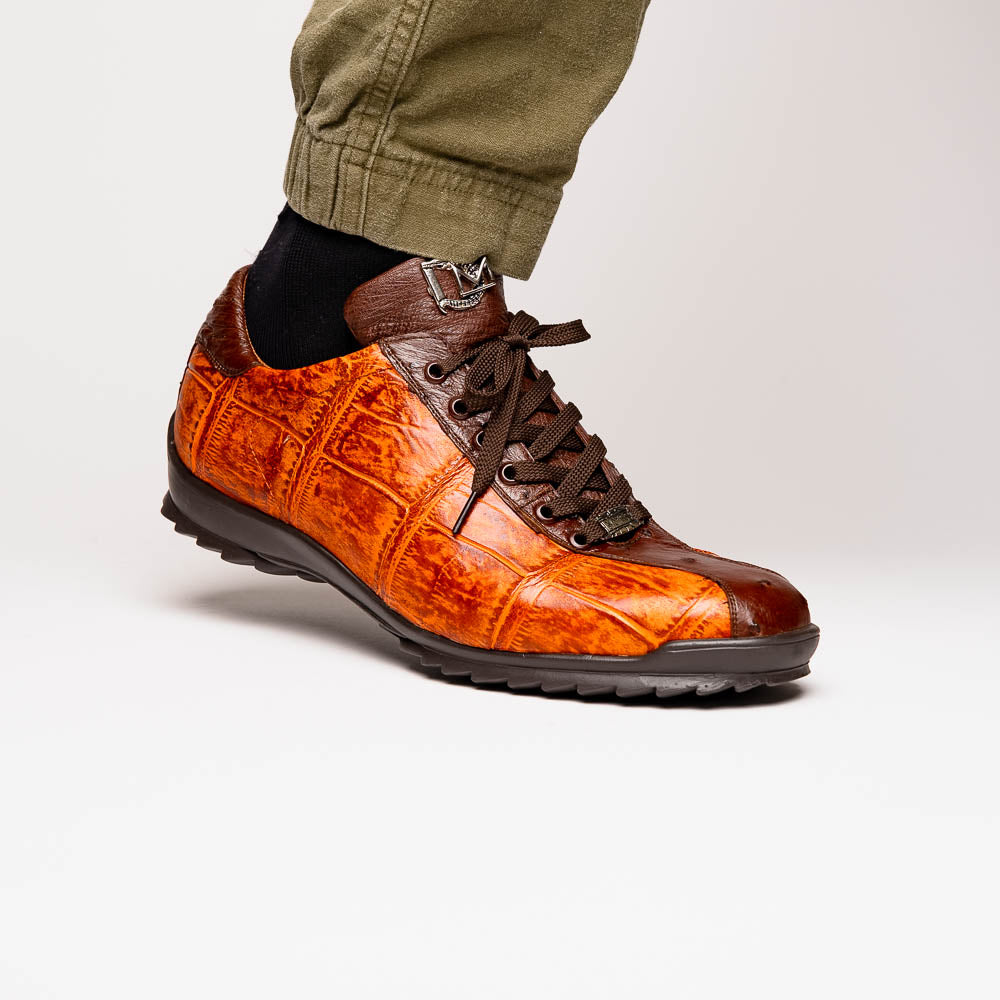 The Saulo Brandy / Brown sneakers by Marco Di Milano feature genuine brown alligator, black soles, dark brown laces, and metallic logo accents—luxury men's footwear displayed against a white background.