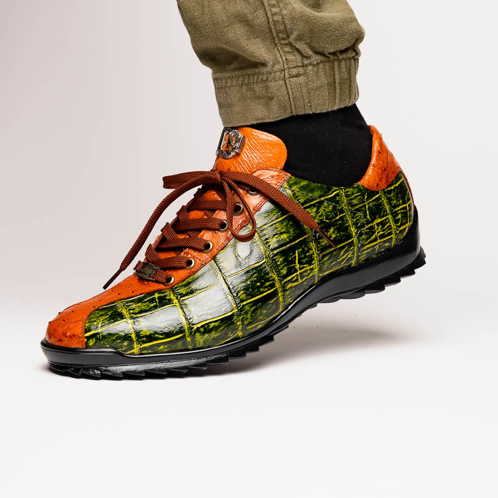 The Saulo Green / Cognac by Marco Di Milano is a luxury men's sneaker with an orange and green crocodile pattern, brown laces, black sole, and metallic tongue emblem—ideal for those wanting an authentic alligator look.