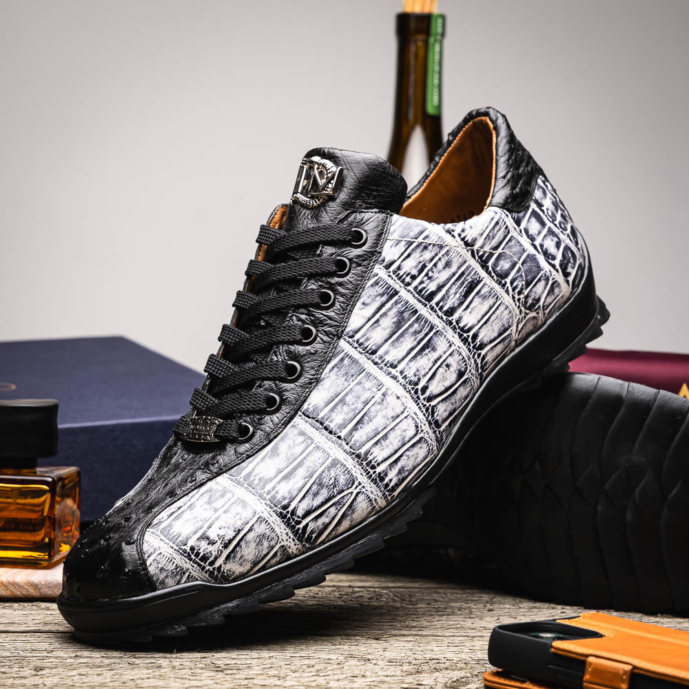 The Saulo Newspaper / Black sneakers by Marco Di Milano are luxury men's shoes featuring a black and white crocodile pattern, black laces, and a textured sole, showcased on a white background.