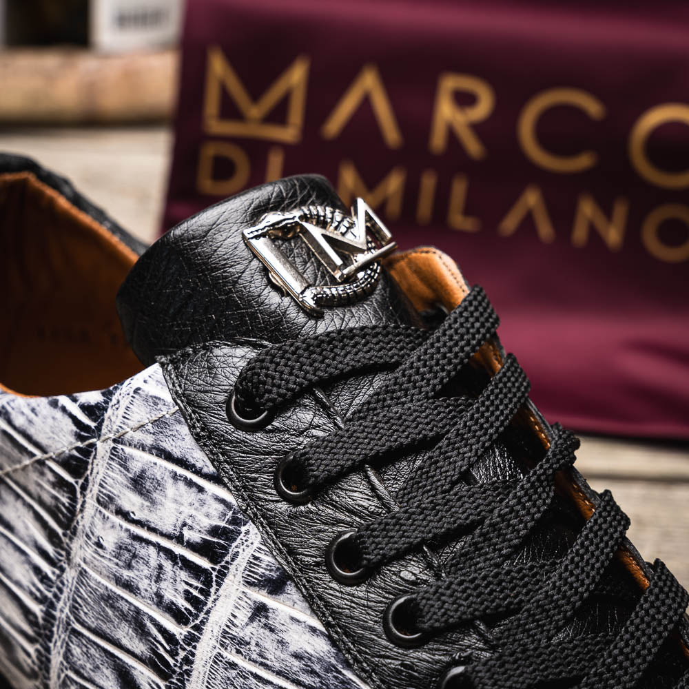 The Saulo Newspaper / Black sneakers by Marco Di Milano are luxury men's shoes featuring a black and white crocodile pattern, black laces, and a textured sole, showcased on a white background.
