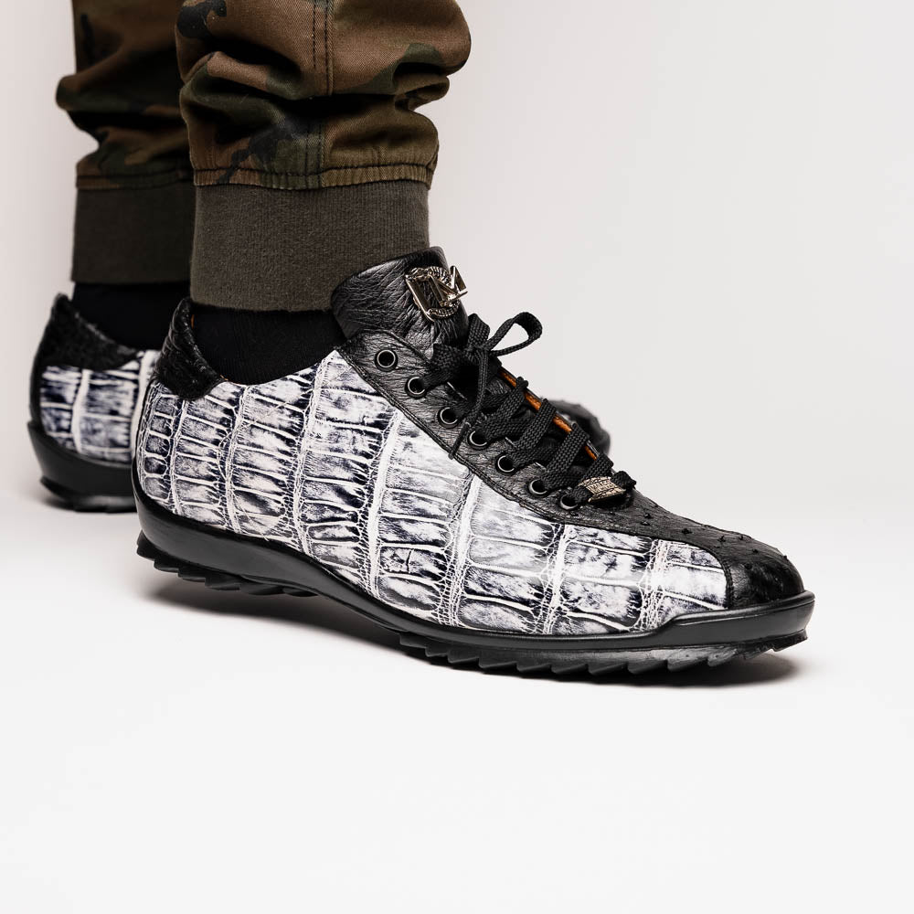 The Saulo Newspaper / Black sneakers by Marco Di Milano are luxury men's shoes featuring a black and white crocodile pattern, black laces, and a textured sole, showcased on a white background.
