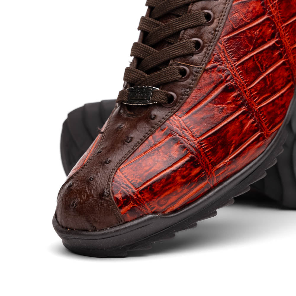 The Saulo Cognac sneakers by Marco Di Milano feature genuine alligator leather in red and brown with black laces and soles—an exceptional luxury men's footwear choice, shown with one upright and the other lying on its side.