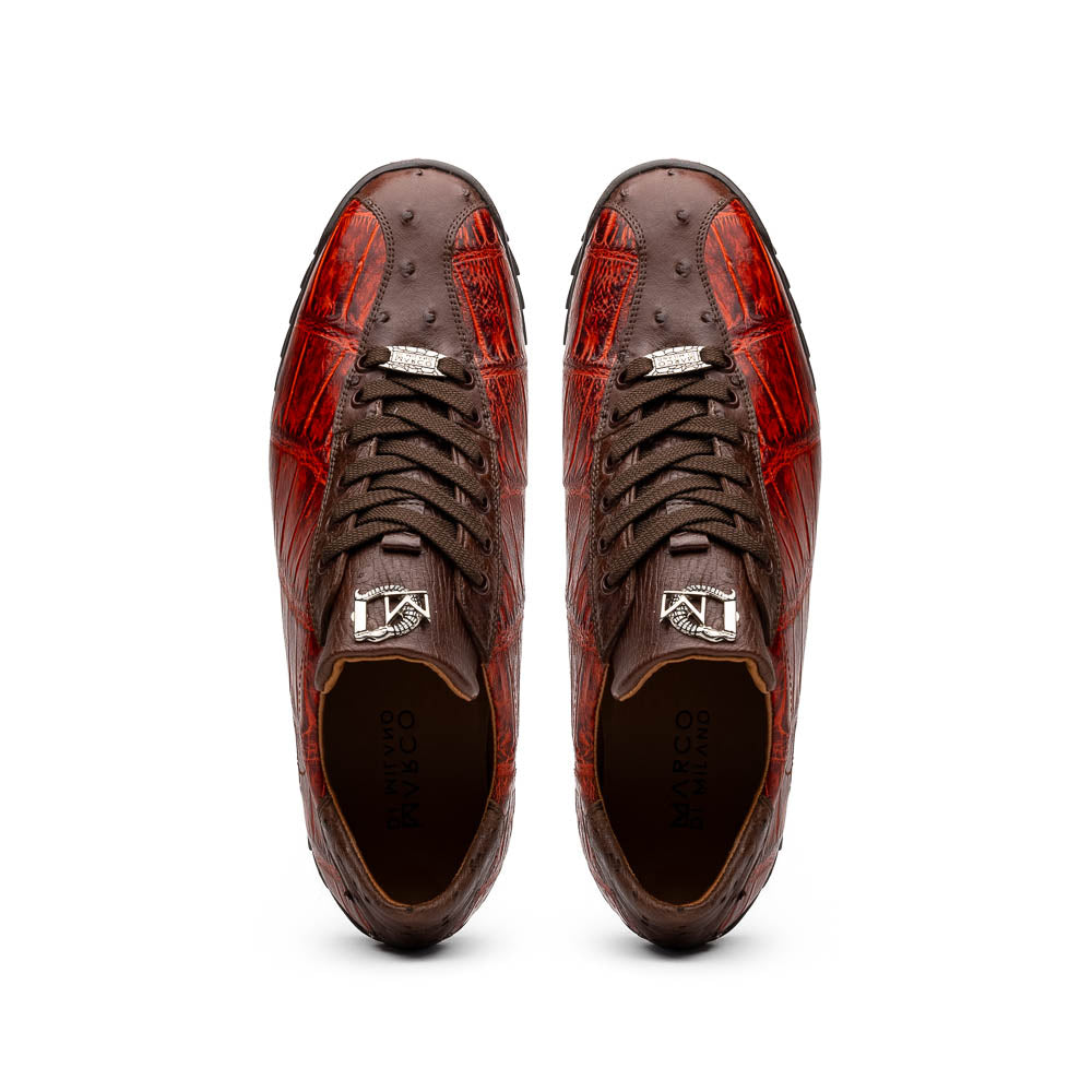 The Saulo Cognac sneakers by Marco Di Milano feature genuine alligator leather in red and brown with black laces and soles—an exceptional luxury men's footwear choice, shown with one upright and the other lying on its side.