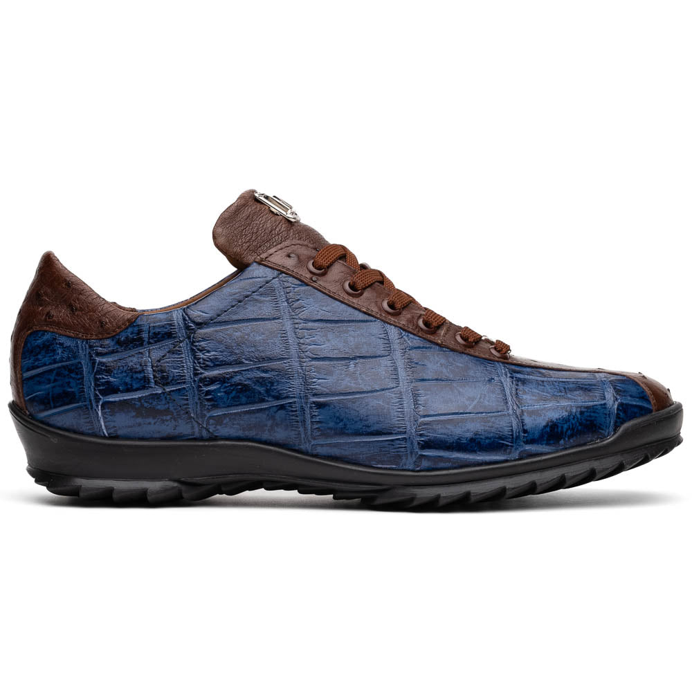 The Marco Di Milano Saulo Blue Jeans is a luxury men's sneaker featuring blue and brown hues, a textured crocodile-like pattern, and a black rubber sole, shown with one shoe upright and the other on its side.