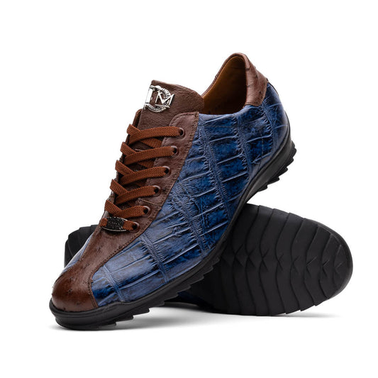 The Marco Di Milano Saulo Blue Jeans is a luxury men's sneaker featuring blue and brown hues, a textured crocodile-like pattern, and a black rubber sole, shown with one shoe upright and the other on its side.