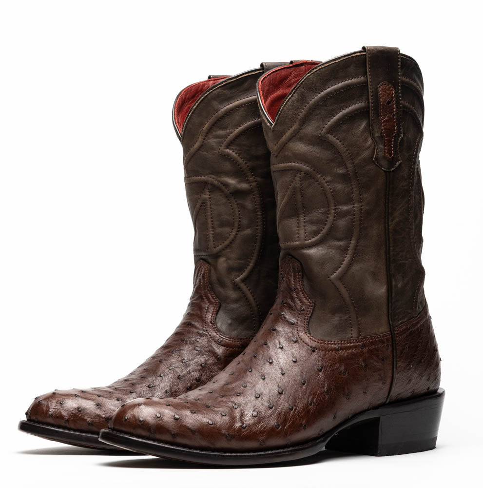 A pair of Marco Di Milano Savannah Kango Tabac boots in brown full-quill ostrich leather, one upright and the other on its side revealing the sole with the "Marco Di Milano" logo.