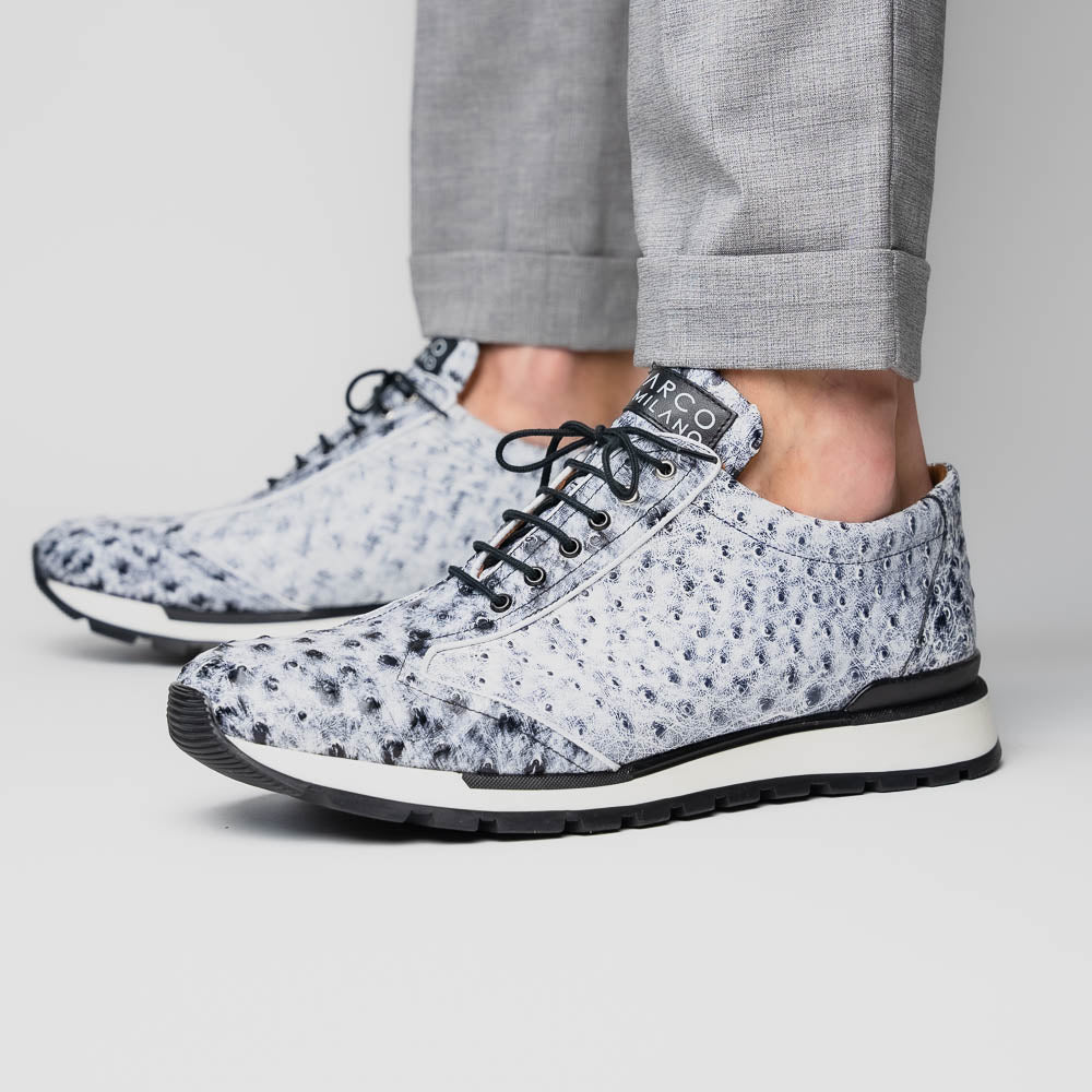 The Marco Di Milano Scanno Newspaper sneakers feature a luxurious hand-painted white and black textured lace-up design with thick black rubber soles, displayed against a plain white background.