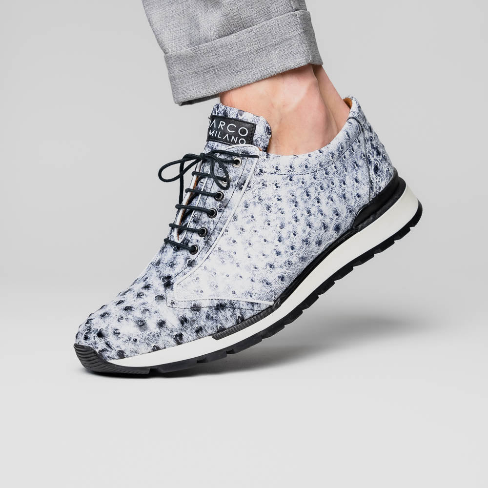 The Marco Di Milano Scanno Newspaper sneakers feature a luxurious hand-painted white and black textured lace-up design with thick black rubber soles, displayed against a plain white background.