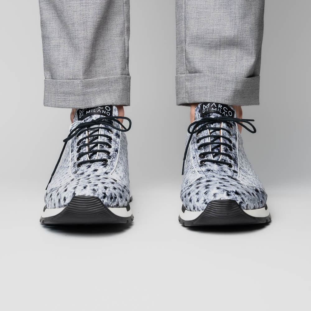 The Marco Di Milano Scanno Newspaper sneakers feature a luxurious hand-painted white and black textured lace-up design with thick black rubber soles, displayed against a plain white background.