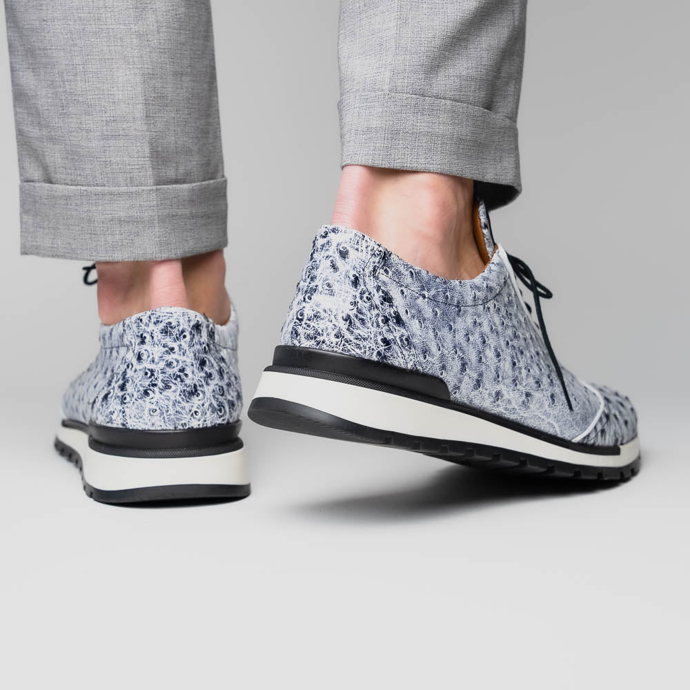 The Marco Di Milano Scanno Newspaper sneakers feature a luxurious hand-painted white and black textured lace-up design with thick black rubber soles, displayed against a plain white background.