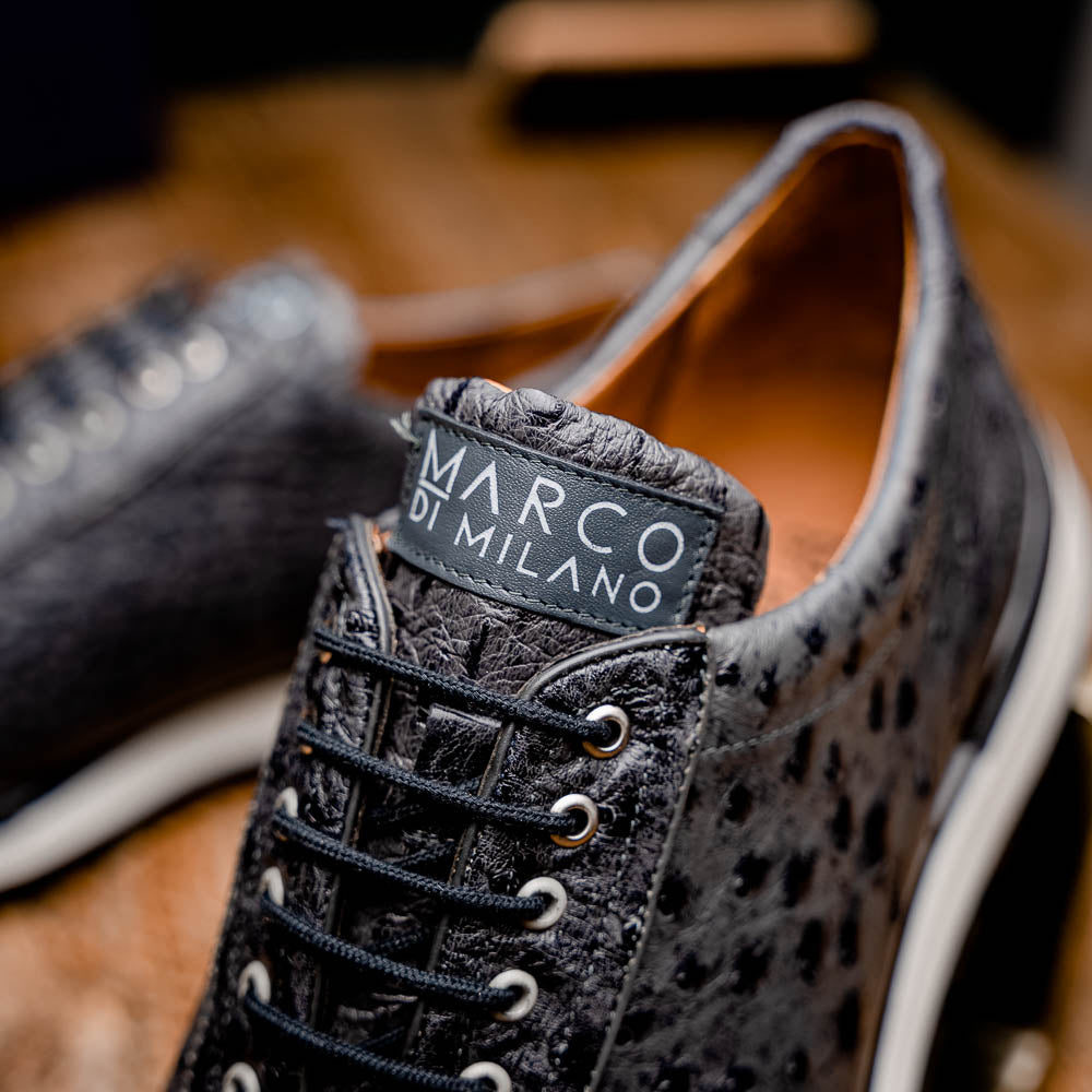 The Marco Di Milano Scanno Antique Gray sneakers feature genuine ostrich quill leather with a hand painted finish, black leather accents, white midsoles, and black rubber outsoles, displayed against a plain white background.