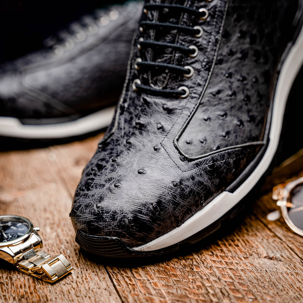 The Marco Di Milano Scanno Antique Gray sneakers feature genuine ostrich quill leather with a hand painted finish, black leather accents, white midsoles, and black rubber outsoles, displayed against a plain white background.