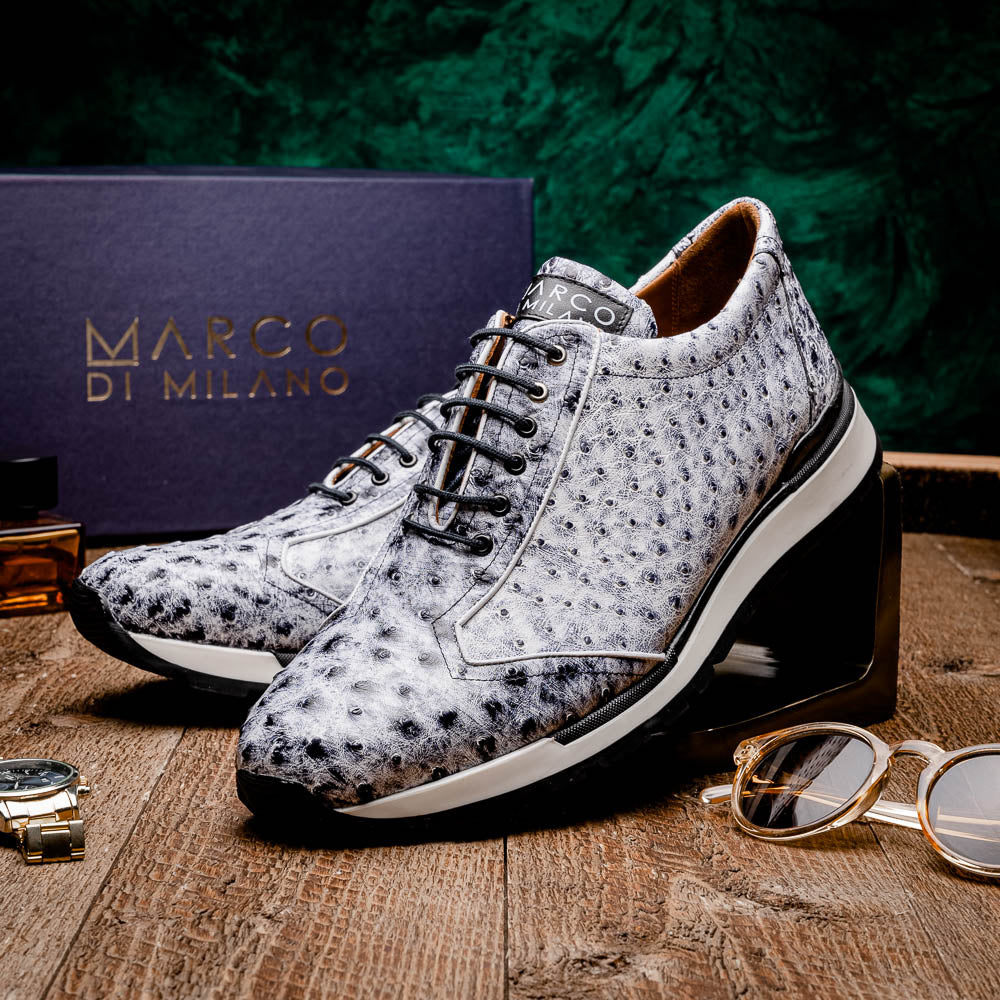 The Marco Di Milano Scanno Newspaper sneakers feature a luxurious hand-painted white and black textured lace-up design with thick black rubber soles, displayed against a plain white background.