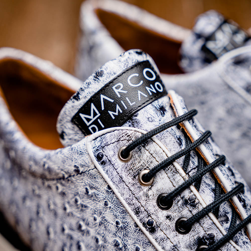 The Marco Di Milano Scanno Newspaper sneakers feature a luxurious hand-painted white and black textured lace-up design with thick black rubber soles, displayed against a plain white background.