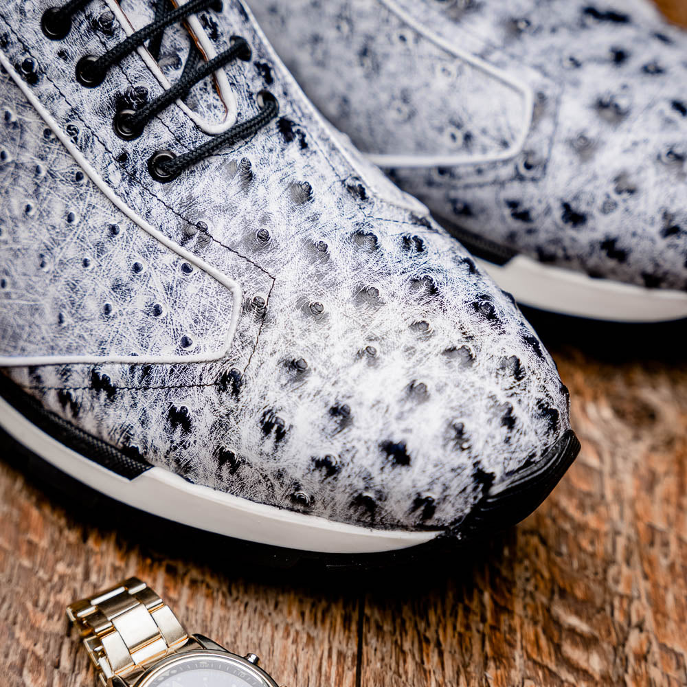 The Marco Di Milano Scanno Newspaper sneakers feature a luxurious hand-painted white and black textured lace-up design with thick black rubber soles, displayed against a plain white background.