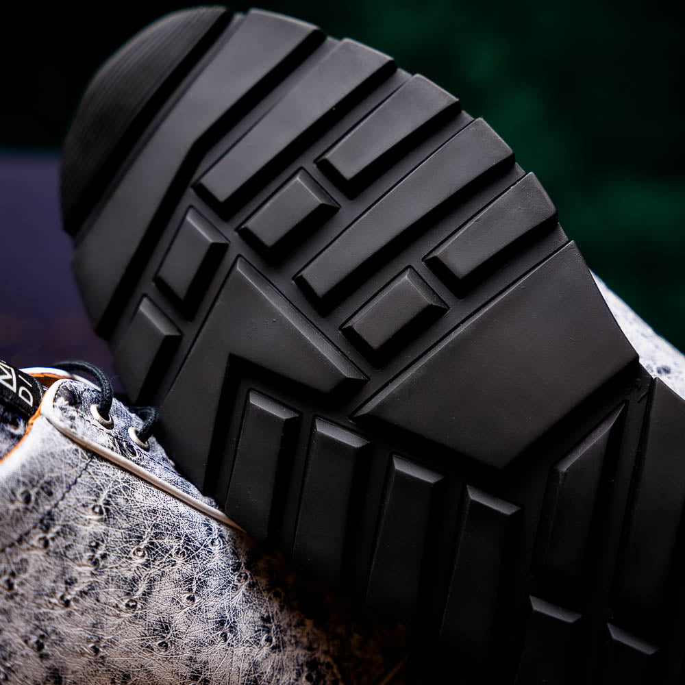 The Marco Di Milano Scanno Newspaper sneakers feature a luxurious hand-painted white and black textured lace-up design with thick black rubber soles, displayed against a plain white background.