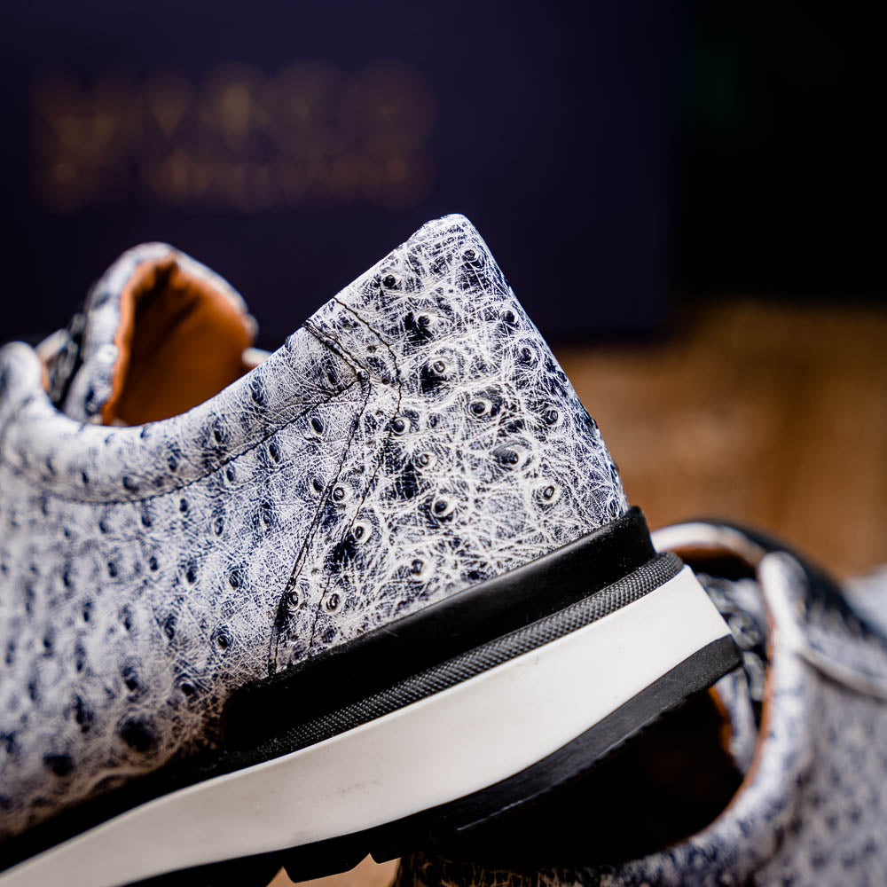 The Marco Di Milano Scanno Newspaper sneakers feature a luxurious hand-painted white and black textured lace-up design with thick black rubber soles, displayed against a plain white background.