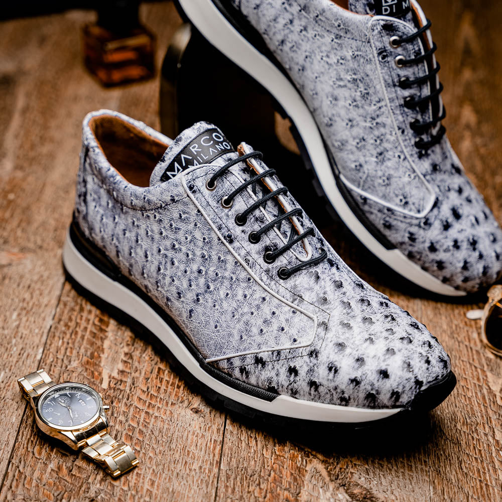 The Marco Di Milano Scanno Newspaper sneakers feature a luxurious hand-painted white and black textured lace-up design with thick black rubber soles, displayed against a plain white background.