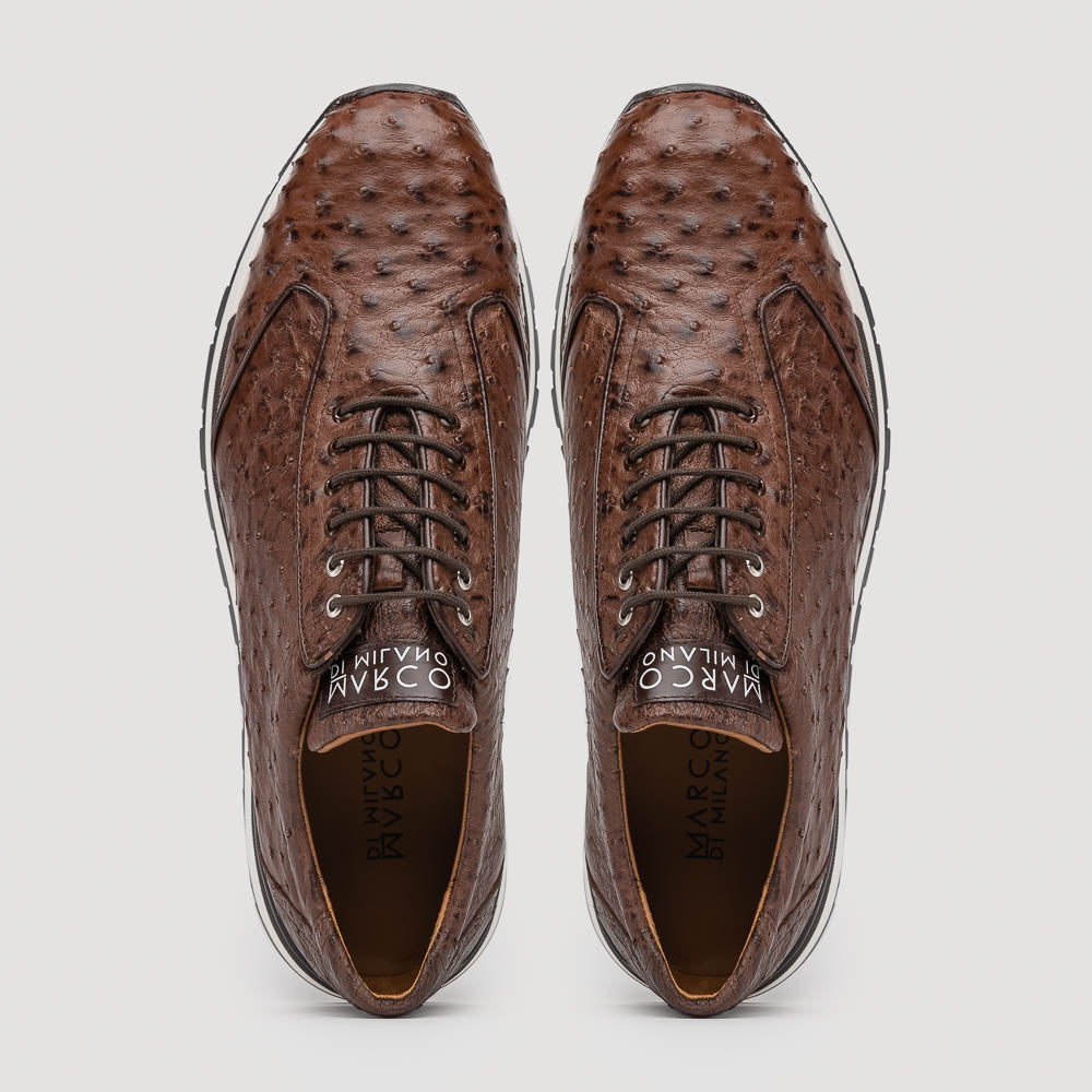 The Scanno Antique Brown sneaker by Marco Di Milano features genuine ostrich quill leather in brown, black laces, and a white-and-black rubber sole. One shoe stands upright while the other rests on its side, highlighting the hand-painted finish.