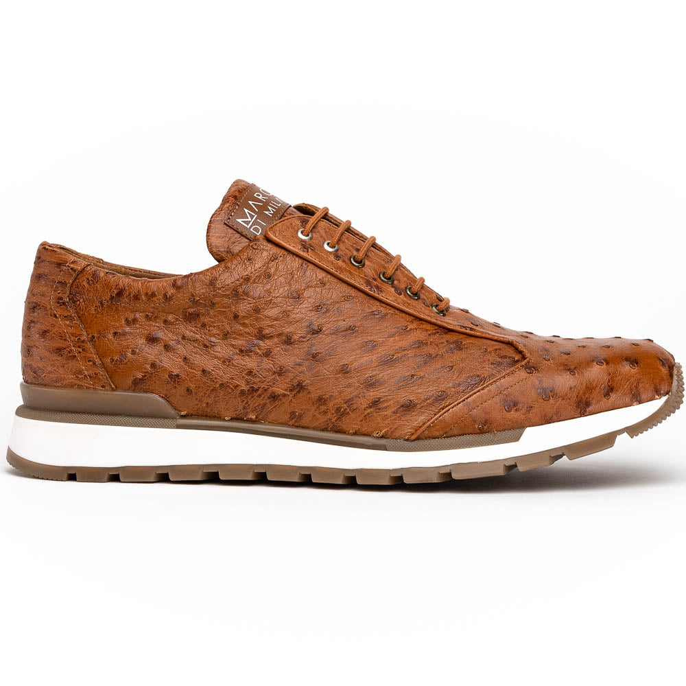 The Scanno Antique Cognac by Marco Di Milano is a brown leather sneaker with an ostrich-patterned, hand-painted finish, white midsole, brown outsole, and brand logo on the tongue—ideal for genuine ostrich quill sneaker fans. Photographed on a plain background.