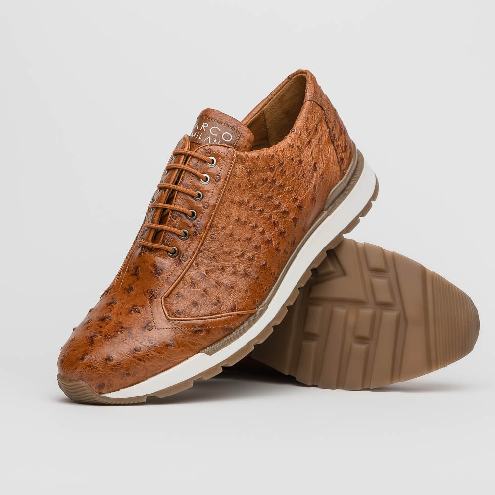 The Scanno Antique Cognac by Marco Di Milano is a brown leather sneaker with an ostrich-patterned, hand-painted finish, white midsole, brown outsole, and brand logo on the tongue—ideal for genuine ostrich quill sneaker fans. Photographed on a plain background.
