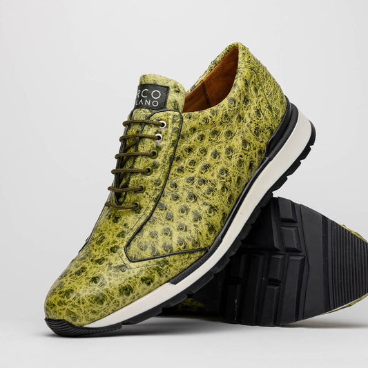 The Marco Di Milano Scanno Antique Green sneakers feature textured genuine ostrich quill in green, black laces, and white soles, with one shoe upright and the other propped beneath—exuding luxury footwear style.