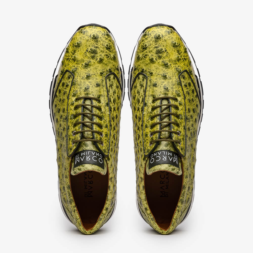 The Marco Di Milano Scanno Antique Green sneakers feature textured genuine ostrich quill in green, black laces, and white soles, with one shoe upright and the other propped beneath—exuding luxury footwear style.