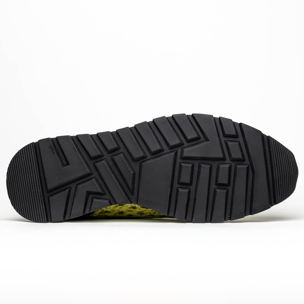 The Marco Di Milano Scanno Antique Green sneakers feature textured genuine ostrich quill in green, black laces, and white soles, with one shoe upright and the other propped beneath—exuding luxury footwear style.