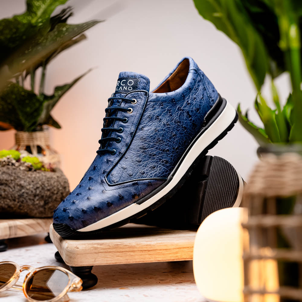 The Marco Di Milano Scanno Antique Navy sneaker features genuine ostrich quill leather in blue, black laces, a white and black rubber sole, and textured details—luxury footwear displayed on a white background.