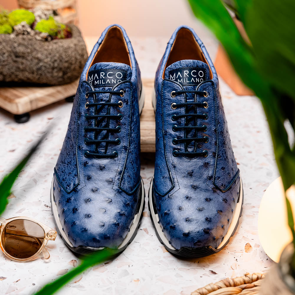 The Marco Di Milano Scanno Antique Navy sneaker features genuine ostrich quill leather in blue, black laces, a white and black rubber sole, and textured details—luxury footwear displayed on a white background.