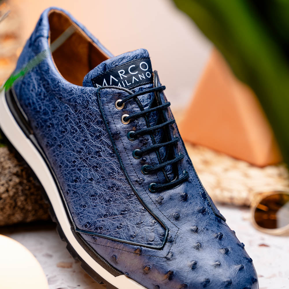The Marco Di Milano Scanno Antique Navy sneaker features genuine ostrich quill leather in blue, black laces, a white and black rubber sole, and textured details—luxury footwear displayed on a white background.