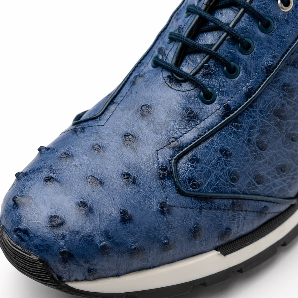 The Marco Di Milano Scanno Antique Navy sneaker features genuine ostrich quill leather in blue, black laces, a white and black rubber sole, and textured details—luxury footwear displayed on a white background.