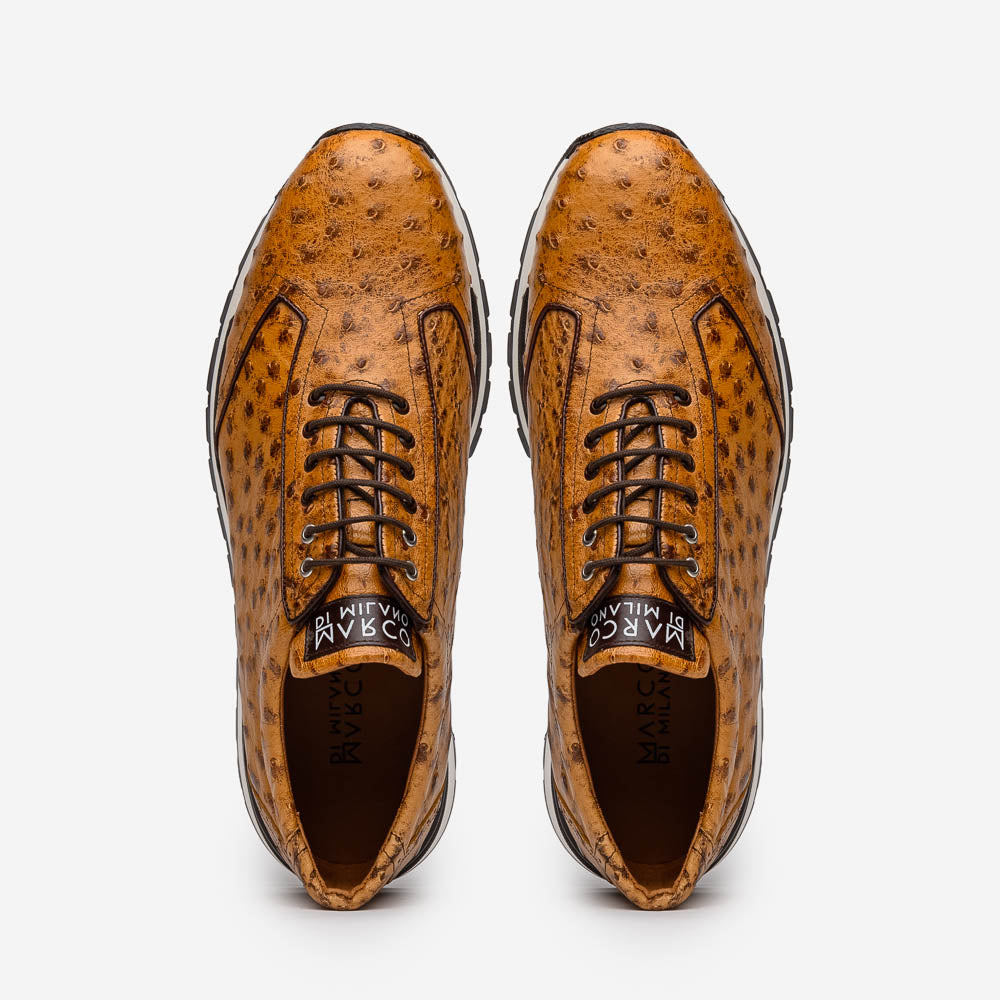 The Scanno Antique Paja sneakers by Marco Di Milano feature real ostrich quill leather with a hand-painted finish, brown leather, black laces, and white-accented soles—one shoe propped on the other against a white background.