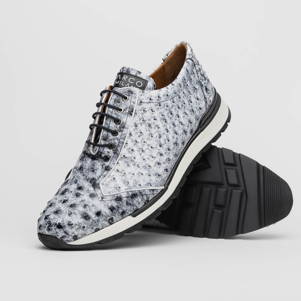 The Marco Di Milano Scanno Newspaper sneakers feature a luxurious hand-painted white and black textured lace-up design with thick black rubber soles, displayed against a plain white background.