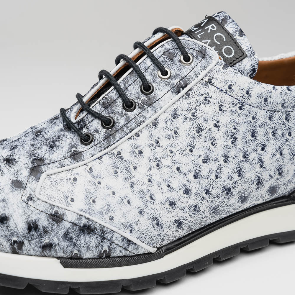 The Marco Di Milano Scanno Newspaper sneakers feature a luxurious hand-painted white and black textured lace-up design with thick black rubber soles, displayed against a plain white background.