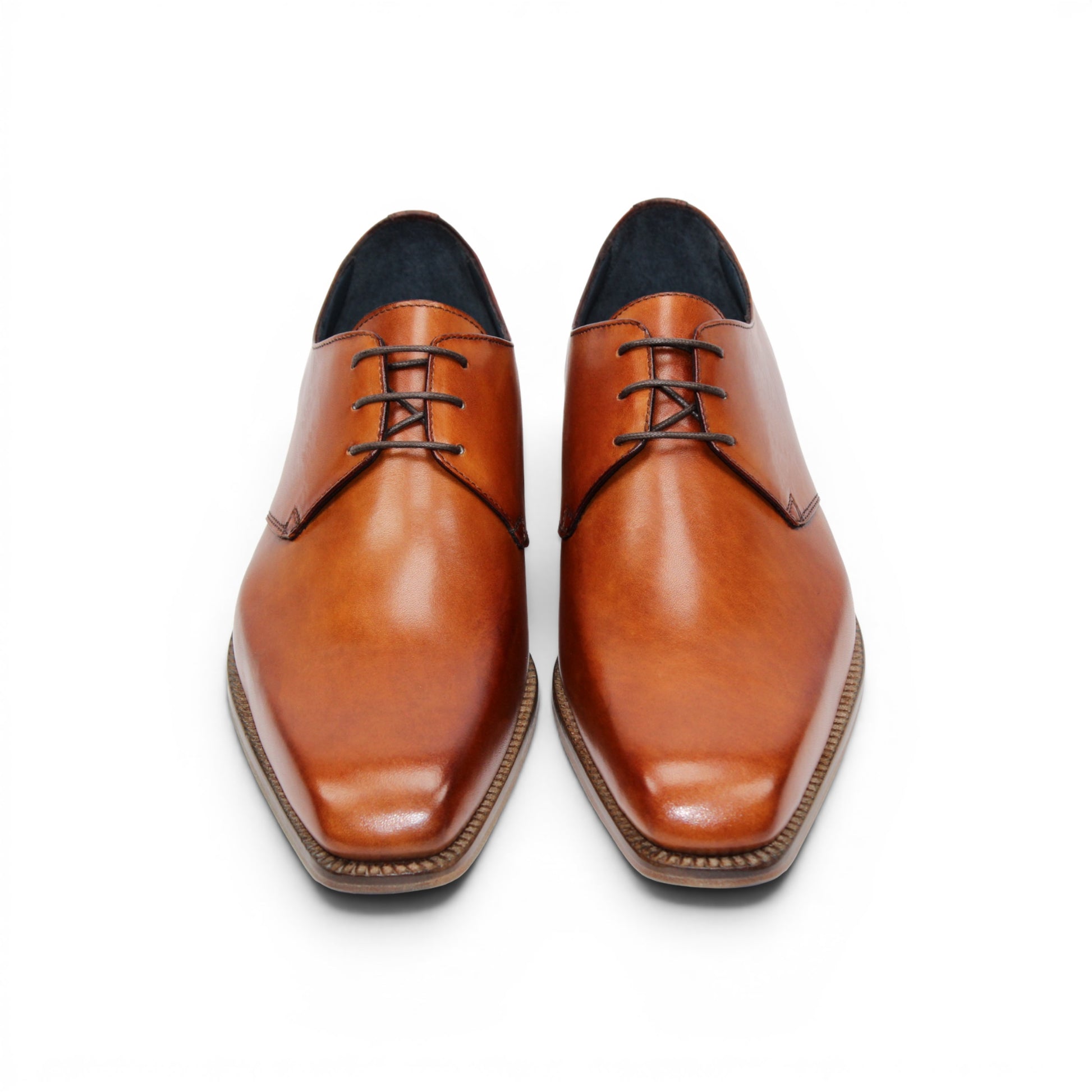 The Duca Sermoneta Cognac by Duca Di Matiste, a classic brown Italian leather dress shoe with a low wooden heel and black lining, is shown in a side view against a white background, highlighting its timeless elegance.